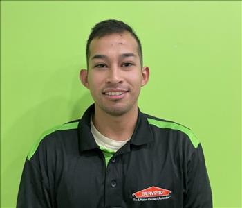 Employee at SERVPRO posing in front of green screen
