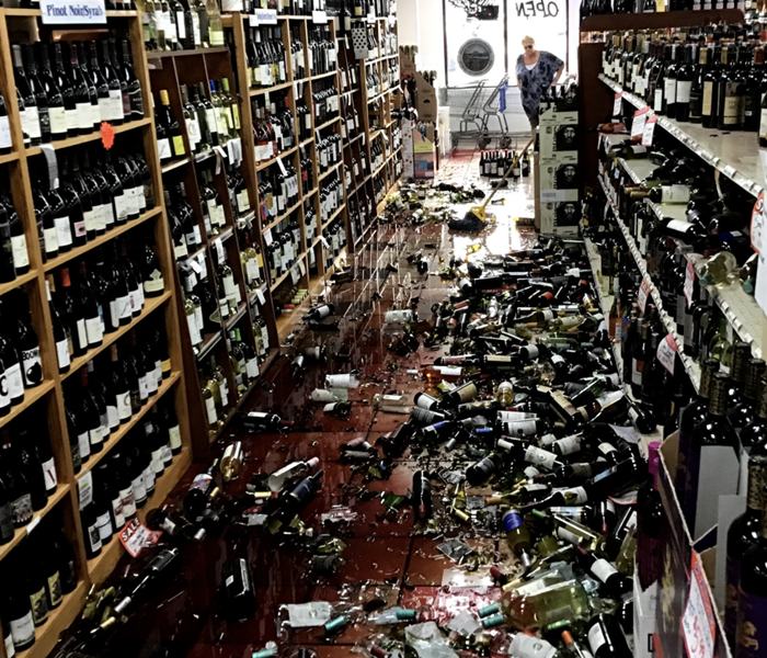 a liquor store with hundreds of broken wine bottles