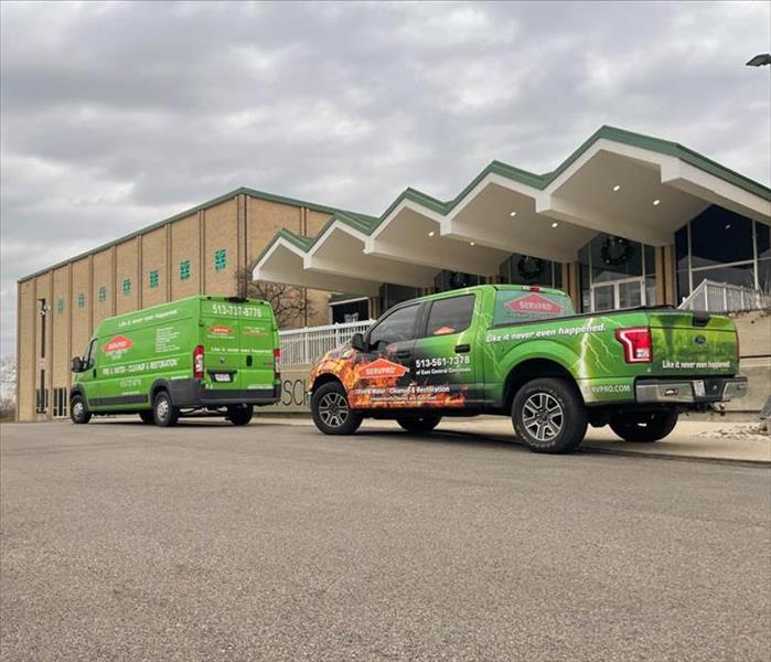 SERVPRo trucks in front of a commercial building.