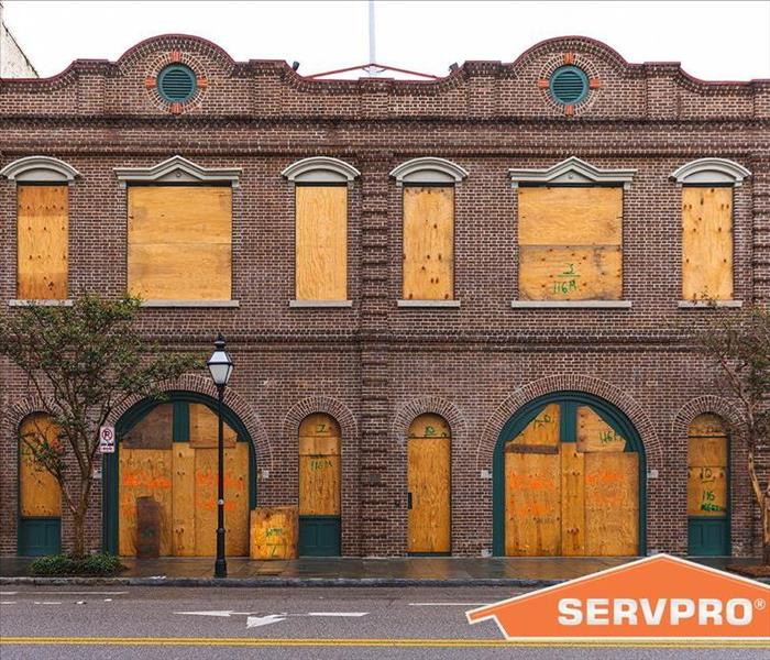 Windows, doors board up of a building, SERVPRO logo on picture.