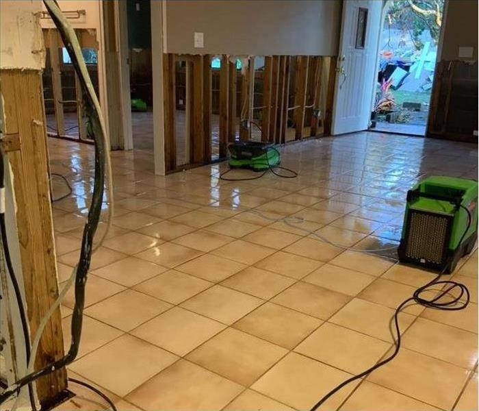 wet floor in a home and drying equipment placed in damaged area