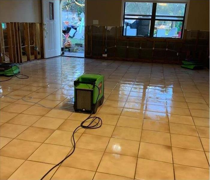wet floor in a home, drywall has been removed due to water damage