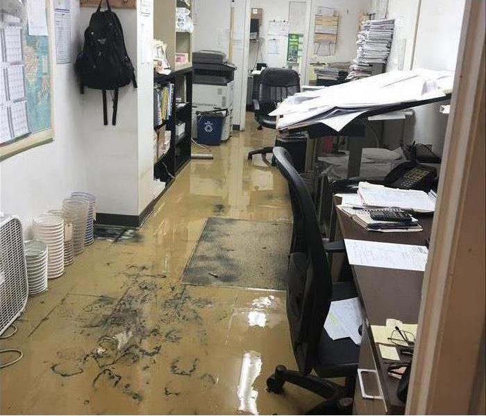 Floor of an office covered with mud due to storm damage